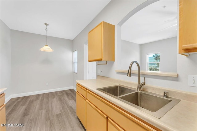 6850 Sharlands Ave Unit U1122, Reno, NV 89523 - kitchen with a sink, light wood-style floors, hanging light fixtures, arched walkways, and light countertops