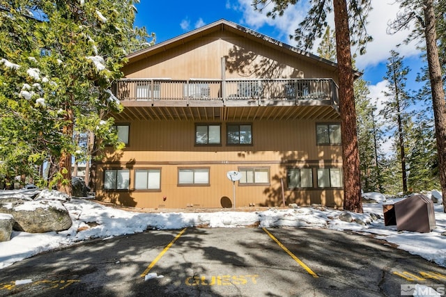 114 Angora Ct Unit A, Zephyr Cove, NV 89448 - snow covered back of property featuring a balcony and uncovered parking