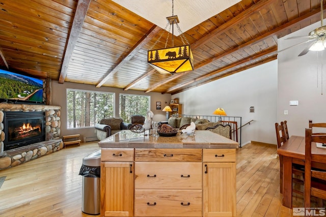 114 Angora Ct Unit A, Zephyr Cove, NV 89448 - kitchen featuring open floor plan, tile countertops, light wood finished floors, a ceiling fan, and a stone fireplace