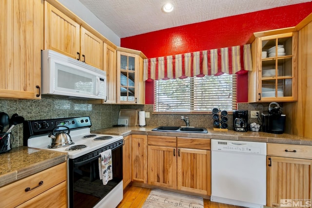 114 Angora Ct Unit A, Zephyr Cove, NV 89448 - kitchen with white appliances, a sink, decorative backsplash, glass insert cabinets, and light wood finished floors