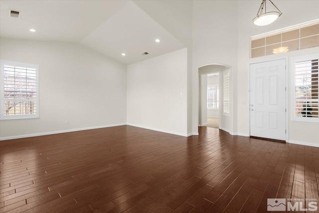 6131 Axis Dr, Sparks, NV 89436 - foyer featuring arched walkways, dark wood-type flooring, healthy amount of natural light, and lofted ceiling