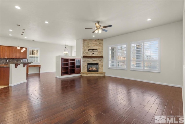 6131 Axis Dr, Sparks, NV 89436 - unfurnished living room with a ceiling fan, dark wood-style flooring, a fireplace, baseboards, and recessed lighting