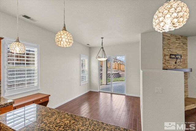 6131 Axis Dr, Sparks, NV 89436 - unfurnished dining area featuring hardwood / wood-style floors, baseboards, and a chandelier