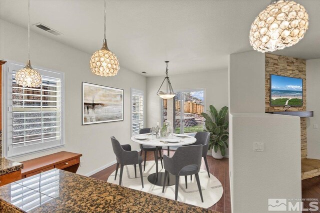 6131 Axis Dr, Sparks, NV 89436 - dining space with dark wood-type flooring, baseboards, and a chandelier