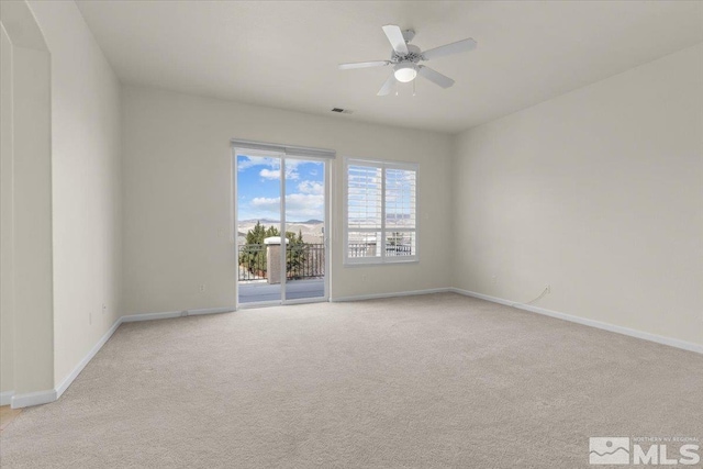 6131 Axis Dr, Sparks, NV 89436 - empty room featuring light carpet, baseboards, and a ceiling fan