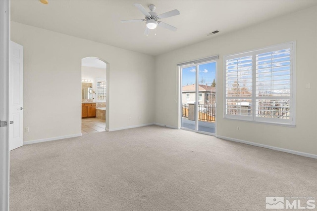 6131 Axis Dr, Sparks, NV 89436 - spare room with arched walkways, light carpet, ceiling fan, and baseboards