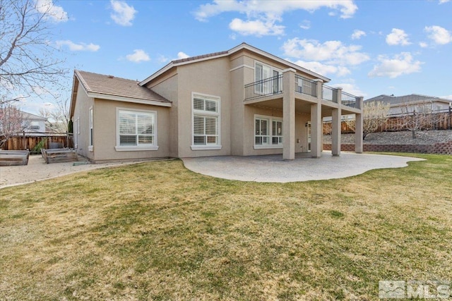 6131 Axis Dr, Sparks, NV 89436 - back of property featuring a balcony, stucco siding, and a patio