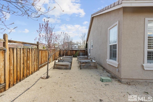 6131 Axis Dr, Sparks, NV 89436 - fenced backyard featuring a garden