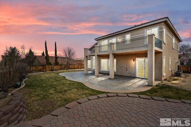 6131 Axis Dr, Sparks, NV 89436 - back of house with stucco siding, a patio, central AC unit, and a balcony