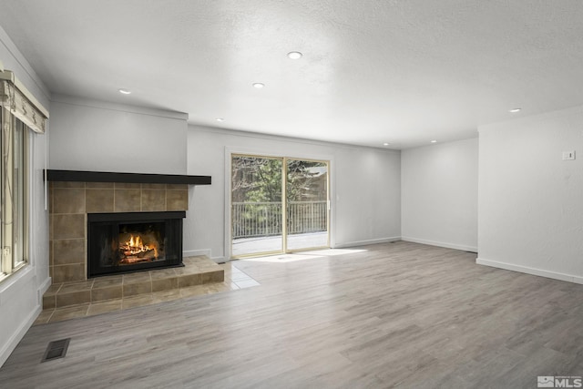 820 Oriole Way Unit 51, Incline Village, NV 89451 - unfurnished living room with a tile fireplace, wood finished floors, recessed lighting, baseboards, and ornamental molding