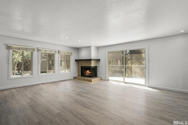 820 Oriole Way Unit 51, Incline Village, NV 89451 - unfurnished living room featuring wood finished floors, a fireplace, a textured ceiling, baseboards, and recessed lighting