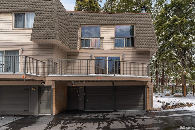 820 Oriole Way Unit 51, Incline Village, NV 89451 - rear view of house featuring a balcony, roof with shingles, a garage, and mansard roof