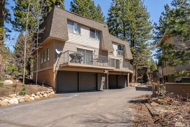820 Oriole Way Unit 51, Incline Village, NV 89451 - view of front of house featuring mansard roof, a shingled roof, and a balcony