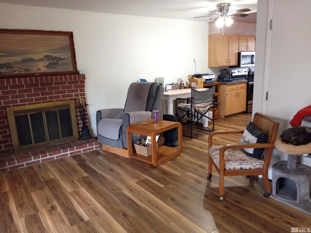 115 Smithridge Park, Reno, NV 89502 - living area with wood finished floors, ceiling fan, a brick fireplace, and a desk