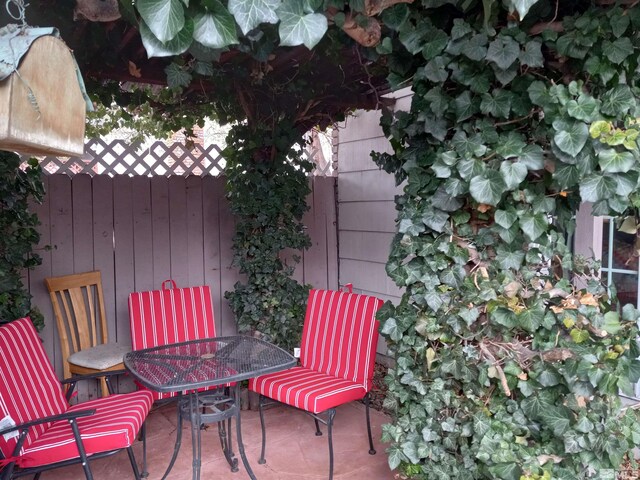 115 Smithridge Park, Reno, NV 89502 - view of patio / terrace with outdoor dining area and fence