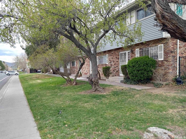 115 Smithridge Park, Reno, NV 89502 - view of side of property featuring brick siding and a lawn