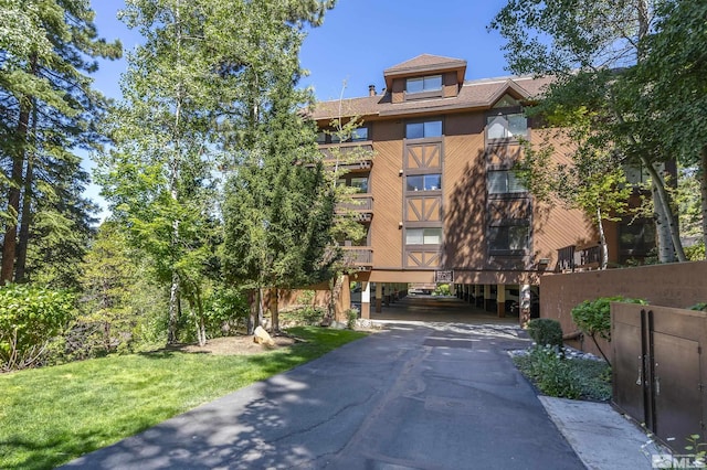 335 Ski Way Unit 313, Incline Village, NV 89451 - view of property featuring a carport, asphalt driveway, and fence