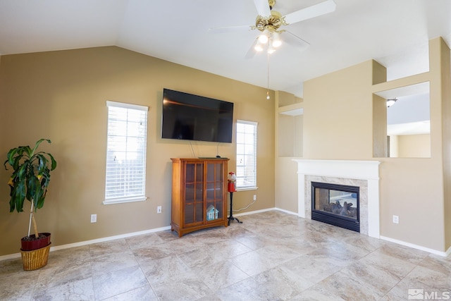 1056 Greenwing Dr, Sparks, NV 89441 - living area with a high end fireplace, ceiling fan, lofted ceiling, and baseboards