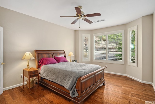 bedroom with baseboards, wood finished floors, and ceiling fan