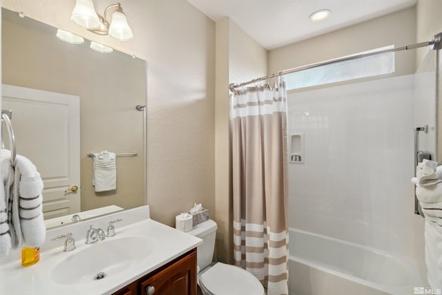 full bath with toilet, vanity, and shower / bath combo