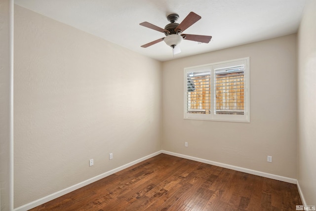 empty room featuring wood-type flooring, baseboards, and a ceiling fan