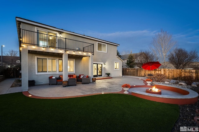 2191 Talladega Ct, Sparks, NV 89436 - rear view of property with a balcony, a patio, an outdoor living space with a fire pit, and stucco siding