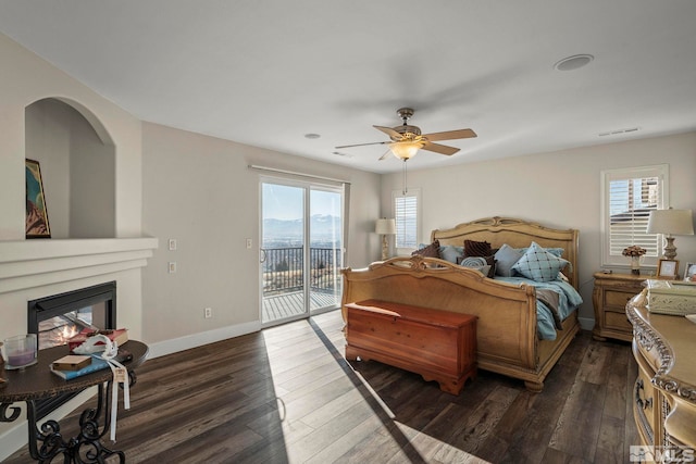 2191 Talladega Ct, Sparks, NV 89436 - bedroom with access to exterior, dark wood-type flooring, a glass covered fireplace, baseboards, and ceiling fan