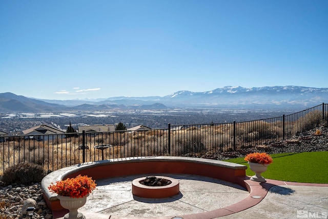 2191 Talladega Ct, Sparks, NV 89436 - view of patio / terrace featuring a mountain view, an outdoor fire pit, and fence