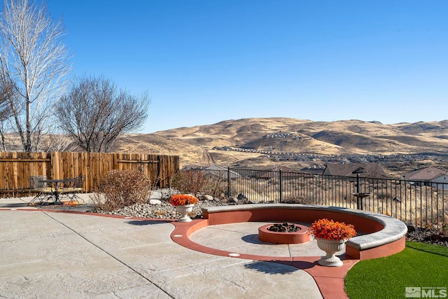 2191 Talladega Ct, Sparks, NV 89436 - view of patio featuring an outdoor fire pit, a fenced backyard, and a mountain view