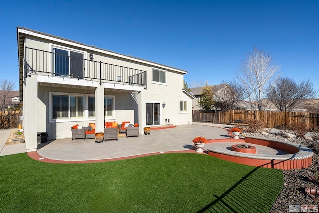 2191 Talladega Ct, Sparks, NV 89436 - rear view of house featuring a balcony, a patio area, stucco siding, and an outdoor living space with a fire pit