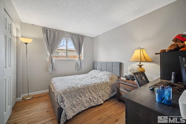 1672 Sue Way, Sparks, NV 89431 - bedroom with wood finished floors, a textured ceiling, and baseboards