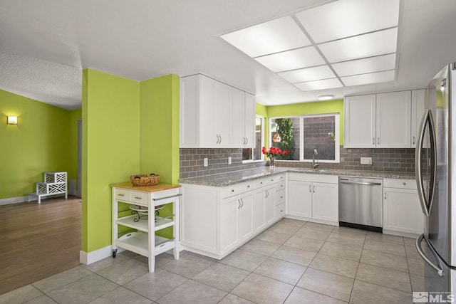 920 Pinebrook Rd, Reno, NV 89509 - kitchen featuring appliances with stainless steel finishes, a sink, white cabinetry, and tasteful backsplash