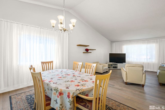 920 Pinebrook Rd, Reno, NV 89509 - dining space featuring vaulted ceiling, a chandelier, and wood finished floors