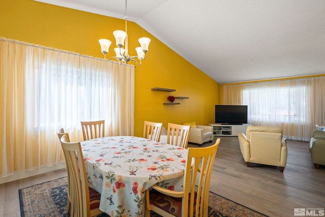 920 Pinebrook Rd, Reno, NV 89509 - dining space featuring vaulted ceiling, a chandelier, plenty of natural light, and wood finished floors