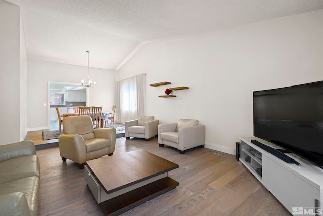 920 Pinebrook Rd, Reno, NV 89509 - living room featuring a chandelier, lofted ceiling, baseboards, and wood finished floors