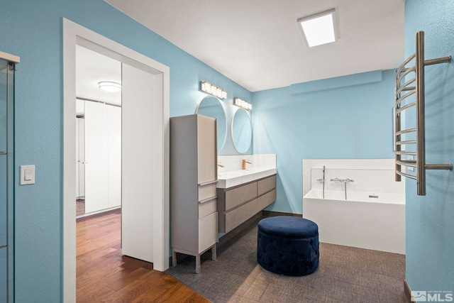920 Pinebrook Rd, Reno, NV 89509 - full bathroom featuring wood finished floors, a bath, vanity, and a towel warming rack