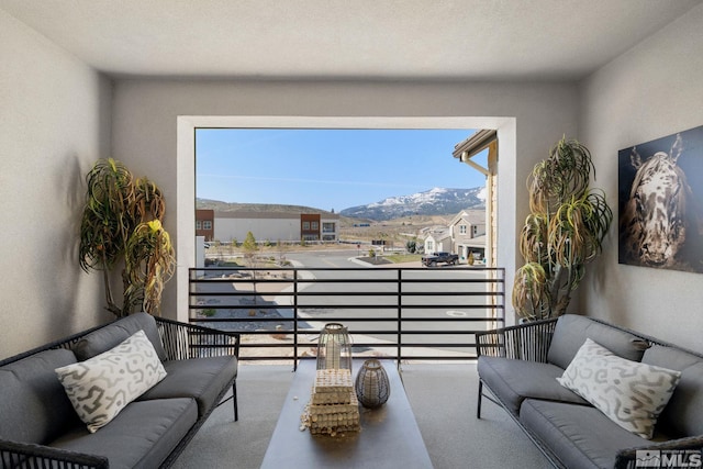 carpeted living room featuring a mountain view