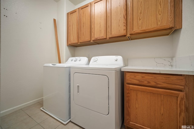 2590 Spring Flower Dr, Reno, NV 89521 - laundry room with cabinet space, washer and clothes dryer, light tile patterned flooring, and baseboards