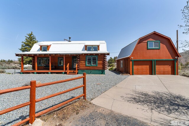 15290 Cherrywood Dr, Reno, NV 89511 - log-style house featuring log exterior, a porch, a barn, a garage, and an outdoor structure