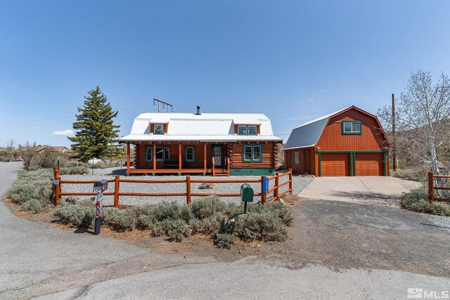 15290 Cherrywood Dr, Reno, NV 89511 - cabin with an outdoor structure, a detached garage, log exterior, a fenced front yard, and covered porch