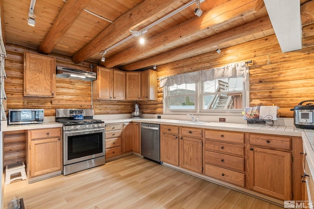 15290 Cherrywood Dr, Reno, NV 89511 - kitchen featuring appliances with stainless steel finishes, track lighting, under cabinet range hood, a sink, and wooden ceiling