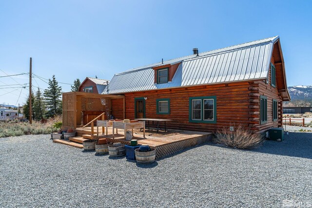 15290 Cherrywood Dr, Reno, NV 89511 - rear view of property featuring metal roof, a deck, log exterior, a gambrel roof, and central AC