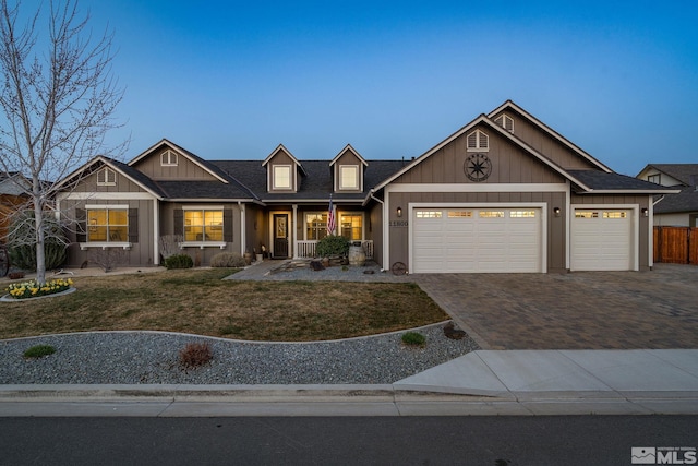 view of front of home featuring a garage, decorative driveway, covered porch, and board and batten siding
