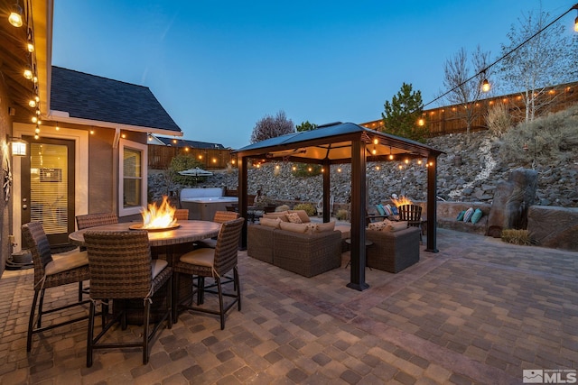 view of patio / terrace with a gazebo and an outdoor living space with a fire pit