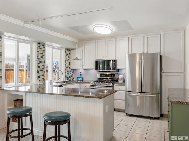 286 Woodlake Cir, Dayton, NV 89403 - kitchen with stainless steel appliances, a sink, rail lighting, white cabinets, and dark stone countertops