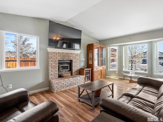 286 Woodlake Cir, Dayton, NV 89403 - living room featuring lofted ceiling, wood finished floors, a brick fireplace, and baseboards
