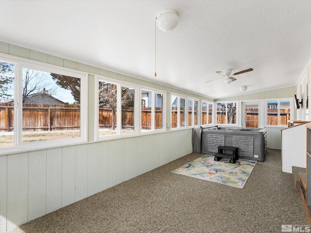 286 Woodlake Cir, Dayton, NV 89403 - sunroom with a hot tub, a wood stove, ceiling fan, carpet flooring, and wood walls