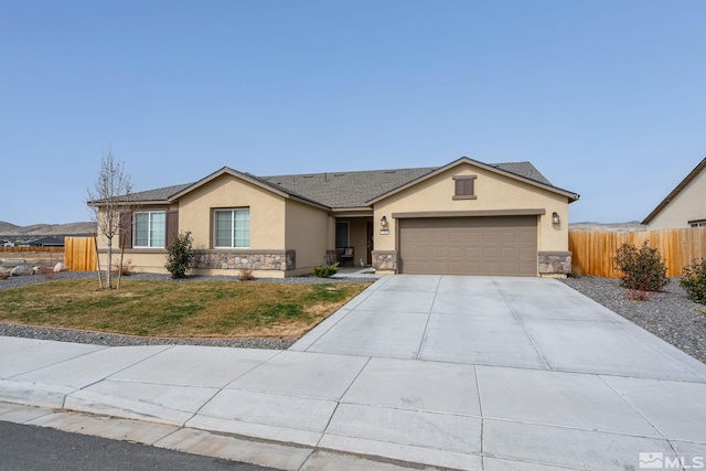 1981 Lanstar Dr, Sparks, NV 89441 - ranch-style home with stucco siding, driveway, an attached garage, and stone siding