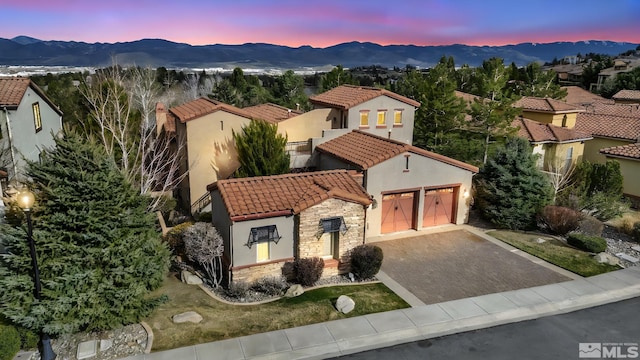 5140 Belsera Ct, Reno, NV 89519 - mediterranean / spanish-style house featuring stone siding, a tiled roof, a mountain view, and stucco siding