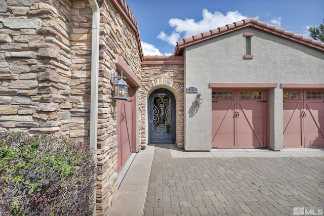5140 Belsera Ct, Reno, NV 89519 - view of front of house with stone siding, stucco siding, a garage, and driveway